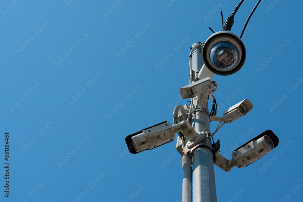 Lots of video cameras on a street pole. Street video surveillance. City security. Surveillance of citizens.