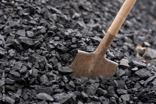 Large pile of coal close up. Shovel in a pile of charcoal. Heating with coal. photo