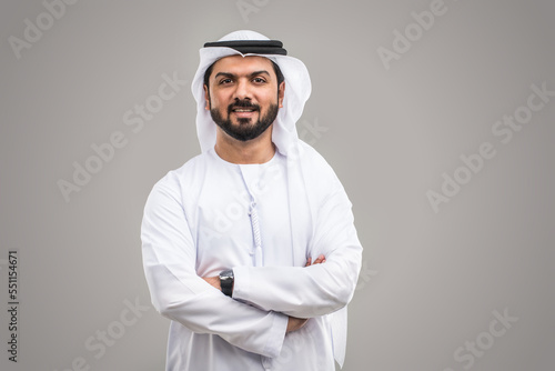 фотографія Handsome arab man wearing traditional emirate clothing portrait in studio - Midd
