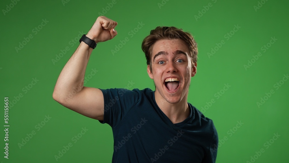 Portrait of young 20s man anticipating and then getting great success winner isolated over green screen background in studio. People sincere emotions slow motions Portrait of young 20s man anticipating and then getting great success winner isolated over green screen background in studio. People sincere emotions slow motions