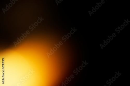 Orange light on black background. Abstract wallpaper