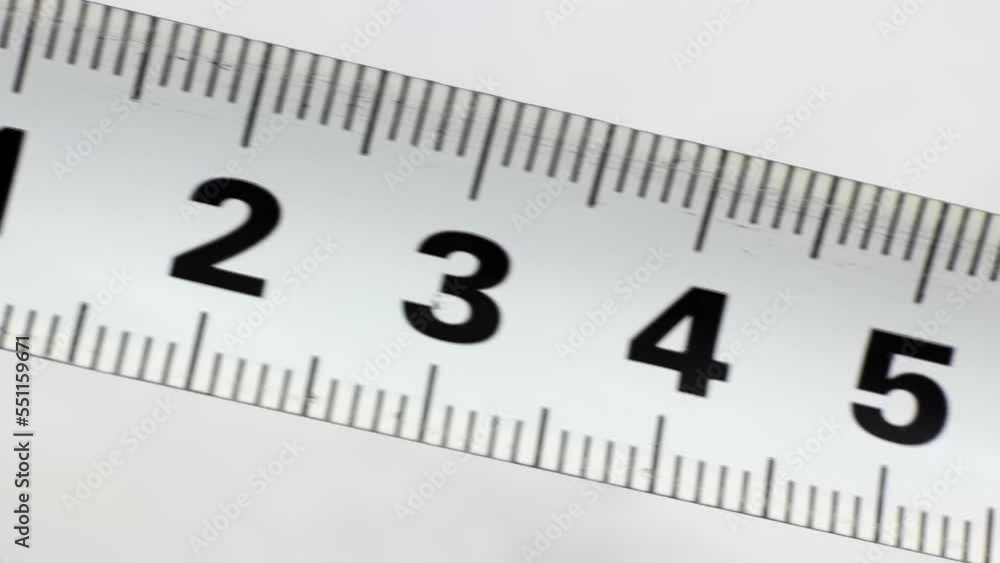 White metal industrial construction tape centimeter measure on light background close up White metal industrial construction tape centimeter measure on light background close up