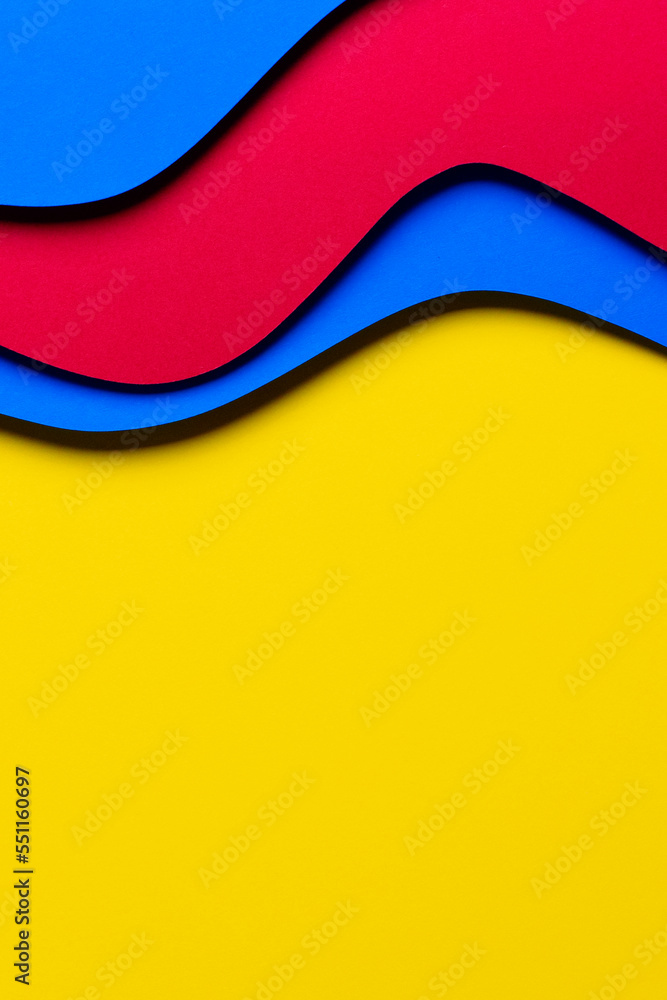 Naklejka premium Abstract colored paper texture background. Minimal paper cut style composition with layers of geometric shapes and lines in red and light blue colors on yellow background. Top view