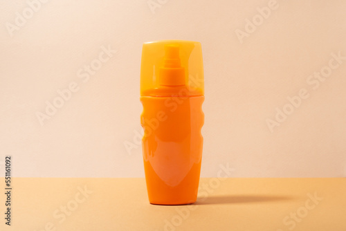 Orange bottle of sunscreen, close-up