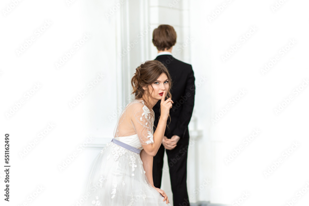 Woman bride in a wedding dress with a beautiful hairstyle, on a light background