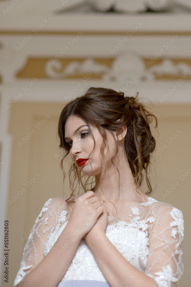 a bride in a patterned wedding dress with a beautiful hairstyle folded her arms across her chest