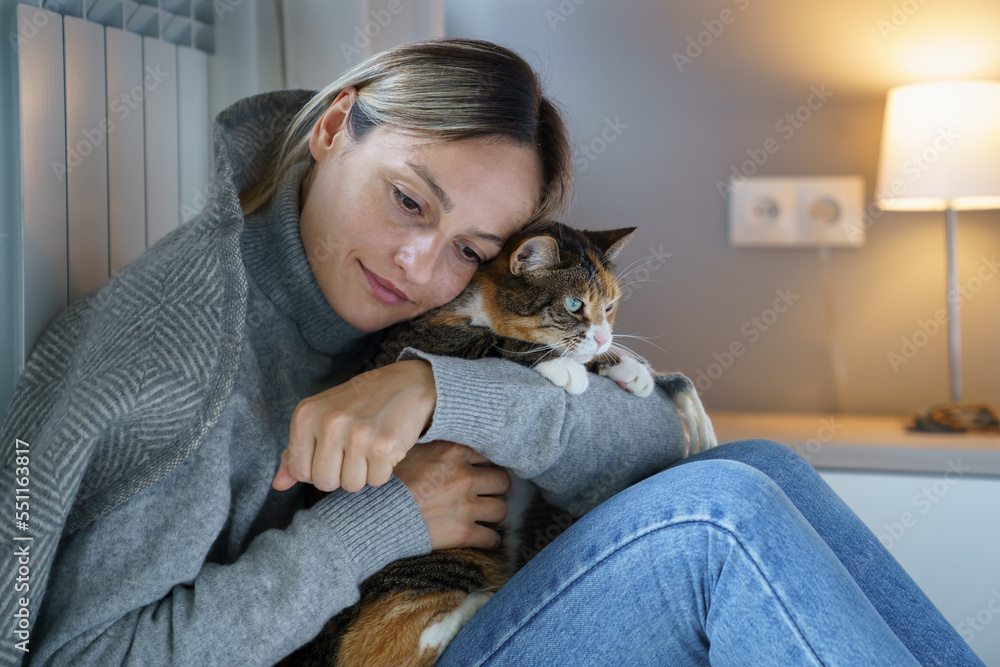 Young woman hugs domestic pet enjoying spending time with favourite cat. Animal makes owner happy and helps to walk through problems and bad thoughts. Female has motivation to make life better Young woman hugs domestic pet enjoying spending time with favourite cat. Animal makes owner happy and helps to walk through problems and bad thoughts. Female has motivation to make life better