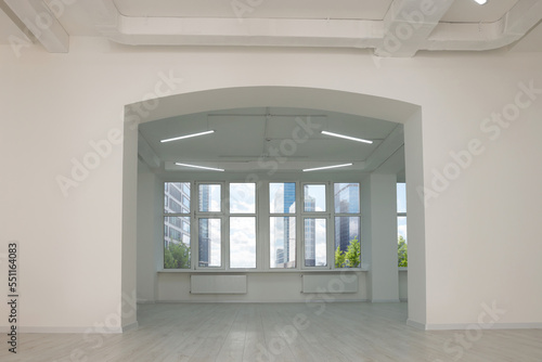 Empty office room with white walls, clean windows and modern lights on ceiling. Interior design