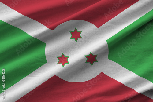 Burundi flag with big folds waving close up under the studio light indoors. The official symbols and colors in fabric banner photo