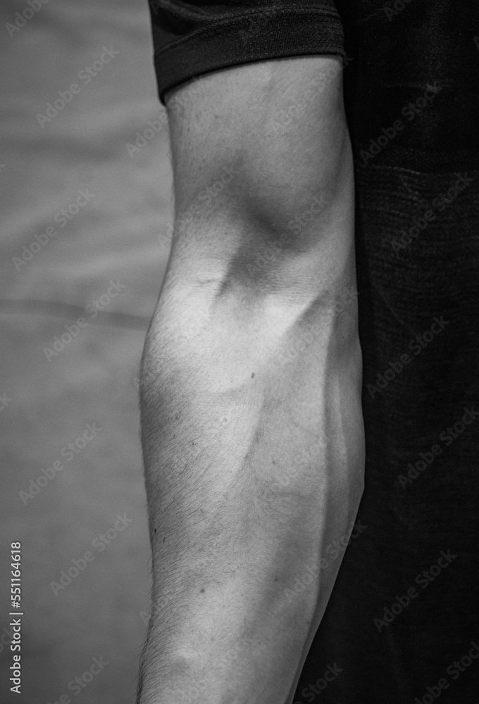 Arm of a muscular climber Contraction of the biceps and triceps Stock