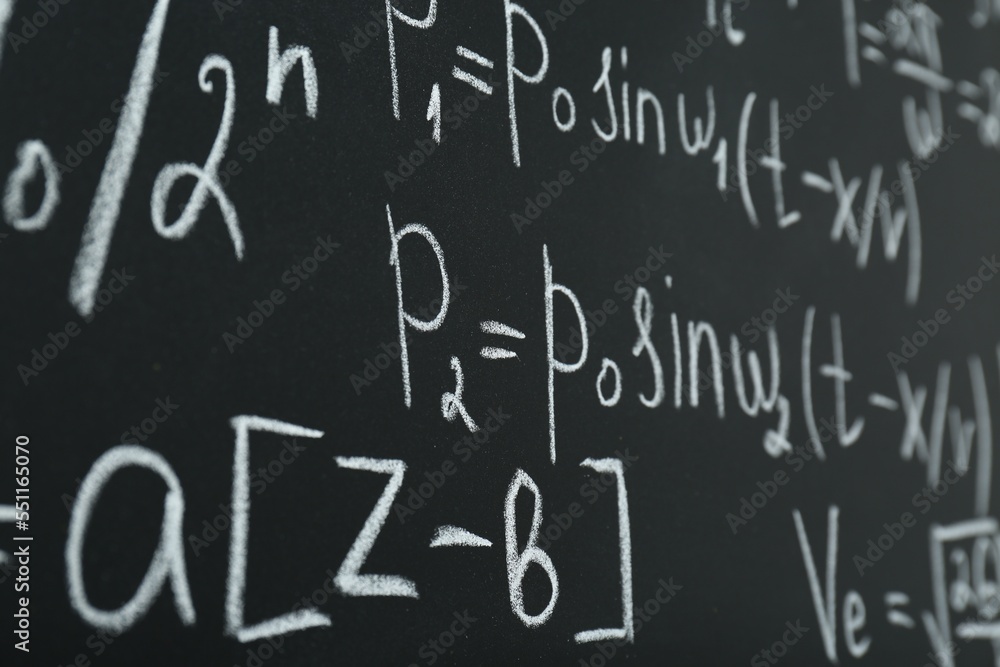Many different math formulas written on chalkboard, closeup Many different math formulas written on chalkboard, closeup