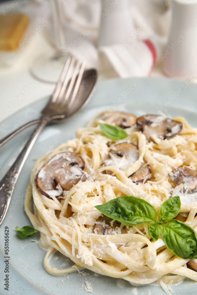 Delicious pasta with mushrooms and cheese on white table, closeup