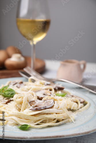 Delicious pasta with mushrooms and cheese on table, closeup