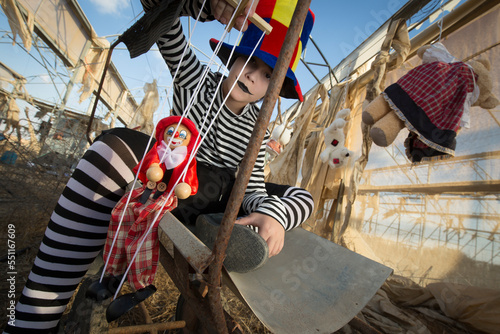 Εκτύπωση καμβά Young clown with scary smile  plays and has fun in an abandoned greenhouse with