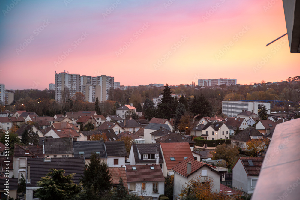 Buildings and houses in the suburbs of Paris, Massy, France under a sunset