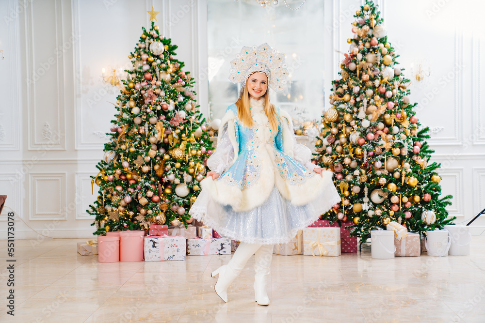 Snow Maiden in costume with short skirt and kokoshnik. room with christmas tree. Snow Maiden in costume with short skirt and kokoshnik. room with christmas tree.