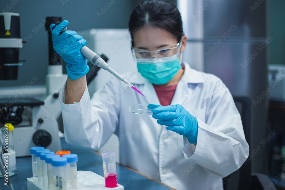 Scientist woman use micropipette with sample preparation from test tube