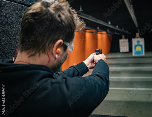 person with gun training in a shooting range in Michigan