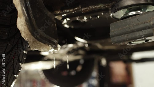 the car is raised on the stand ready for repair, the frozen ice is melting from the wheel arches. High quality 4k footage