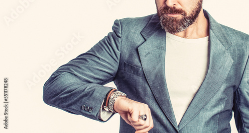 Business man showing time on his wrist watch. Hand in with wrist watch in a business suit. Elegant handsome man in suit. Businessman checking time from watch