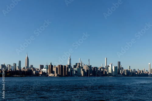 East River Manhattan skyline on a clear sunny day © zxvisual