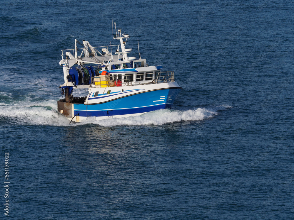 french fishing boat enter in le havre harbour in summer time