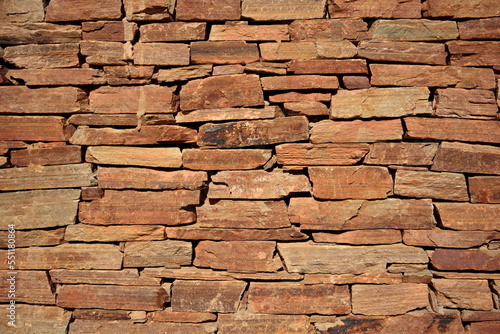 Flagstone wall.  Orange natural stone masonry  background.
