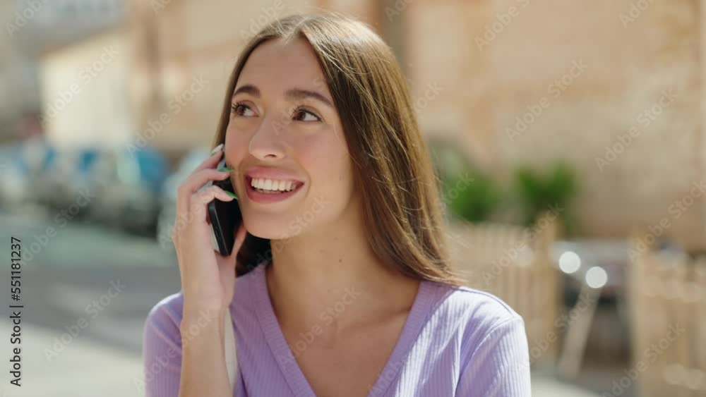 Young beautiful hispanic woman smiling confident talking on the smartphone at street Young beautiful hispanic woman smiling confident talking on the smartphone at street