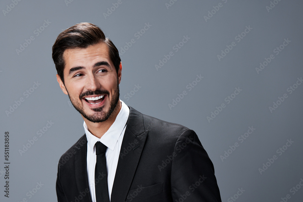 Portrait of a business man with a natural smile with teeth on a gray background in a business suit. Business portrait of a stylish man copy space Portrait of a business man with a natural smile with teeth on a gray background in a business suit. Business portrait of a stylish man copy space