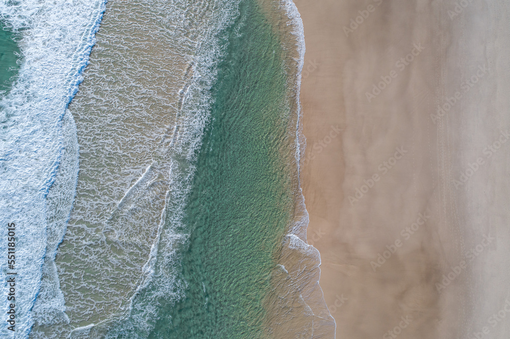 Stunning aerial view of a beach with pristine blue water Stunning aerial view of a beach with pristine blue water