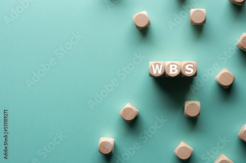 There is wood cubes with the word WBS. It's an abbreviation for Work Breakdown Structure. photo