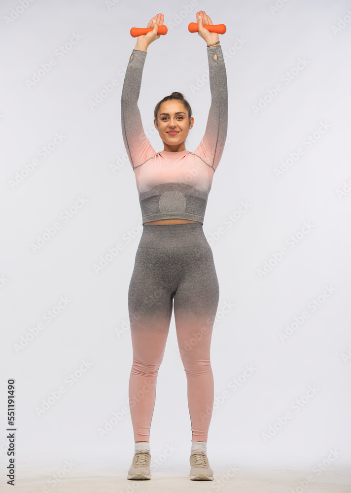 young woman doing fitness exercises on a white background isolated.sports exercises for body shaping young woman doing fitness exercises on a white background isolated.sports exercises for body shaping