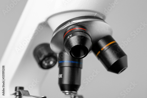 Closeup view of modern medical microscope on grey background