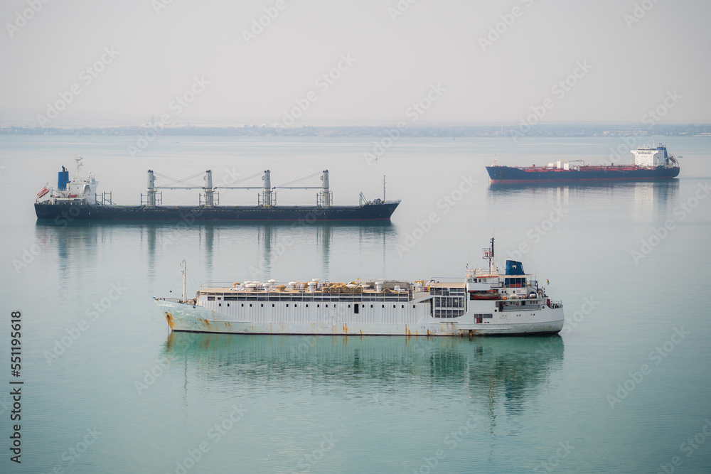 Many cargo ships navigate through Suez Canal. Shipping canal in Egypt. Concept of transportation and logistics Many cargo ships navigate through Suez Canal. Shipping canal in Egypt. Concept of transportation and logistics