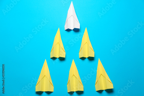 Flat lay composition with paper planes on light blue background