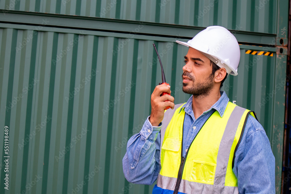 Confident container shipping company male worker using walkie-talkie Confident container shipping company male worker using walkie-talkie