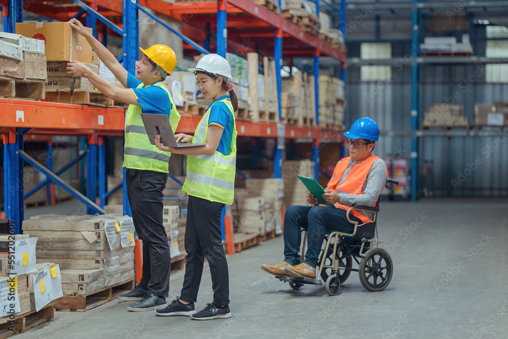 The supervisor is handicapped with a wheelchair inspecting the work background in warehouse.logistic business export ,Warehouse worker checking packages on store The supervisor is handicapped with a wheelchair inspecting the work background in warehouse.logistic business export ,Warehouse worker checking packages on store
