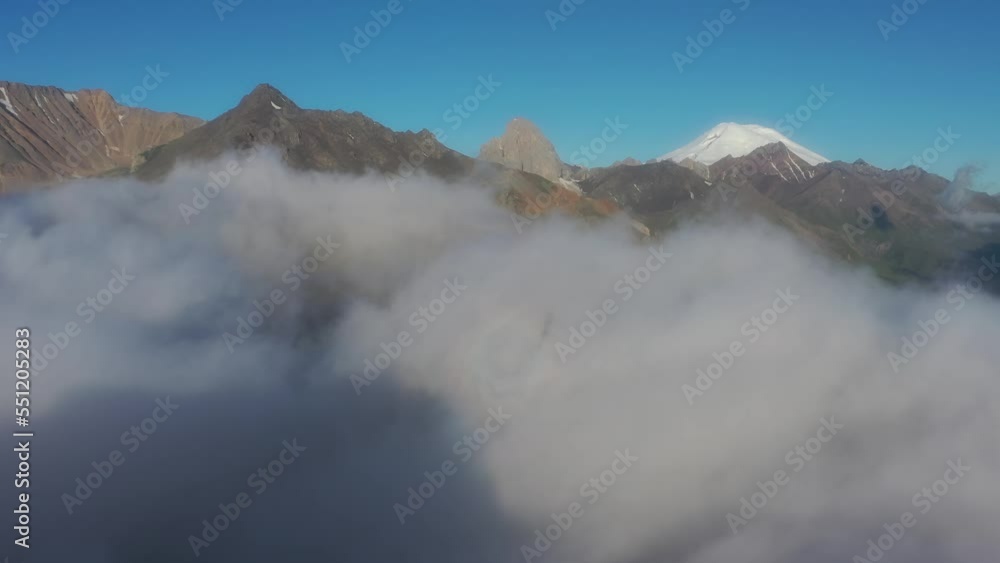 Flying above the clouds. Aerial view of clouds and mountains at sunrise. Traveling by air perfect background, 4k Flying above the clouds. Aerial view of clouds and mountains at sunrise. Traveling by air perfect background, 4k