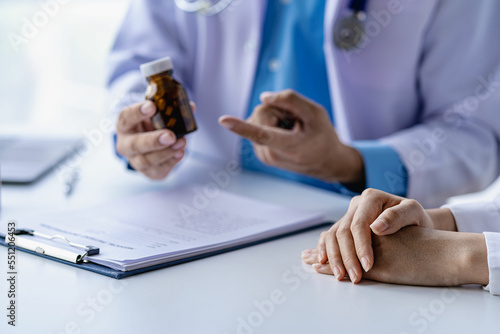 Psychiatrist consulting on women's gynecological diseases, writing prescription clipboard notes, listening to patients received in the clinic hospital.