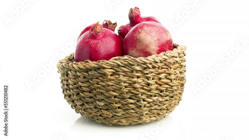 pomegranate in a basket isolated on white background