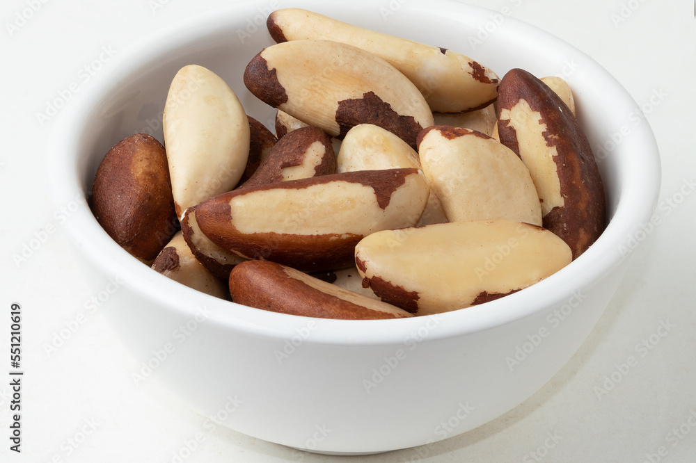 Typical Brazilian nut known as Castanha do Pará in a bowl. Selective focus. Typical Brazilian nut known as Castanha do Pará in a bowl. Selective focus.