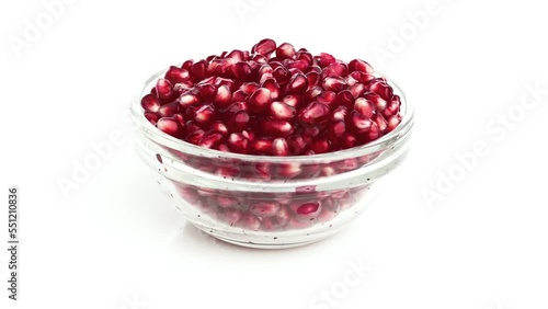 pomegranate seeds in a bowl isolated on white background