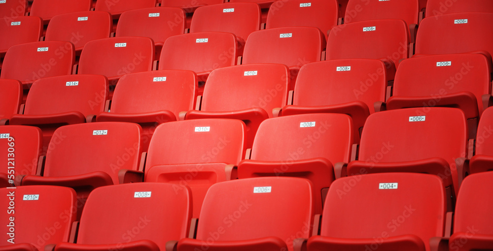 Naklejka premium Row of empty red seats at stadium