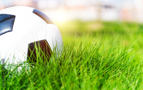 Single soccer football on the green grass