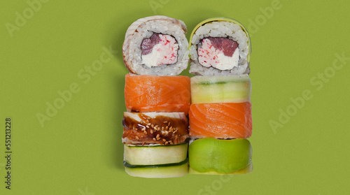 yummy and tasty sushi roll, close-up, from top view with many ingredients, high quality details, isolated on green background, salmon, cheese, crab inside 