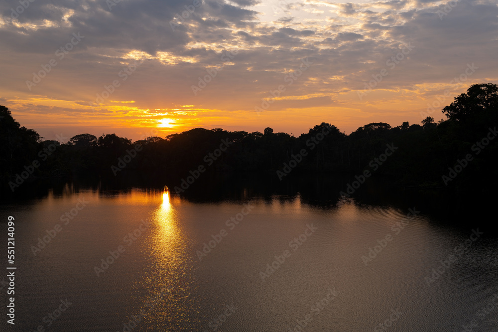 Sunrise reflection in the Amazon Rainforest, Ecuador.