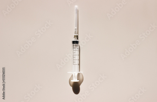 Syringe on a light background. Space for text. View from above. Flatlay.