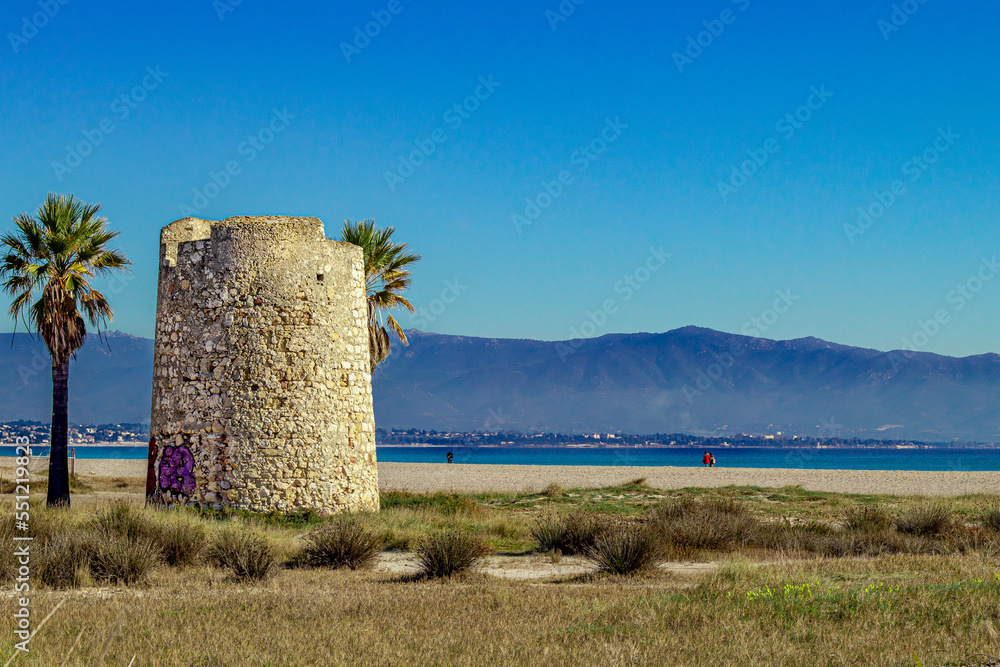 Spanish Tower and palms on Poetto beach. Cagliari, Sardinia, Italy