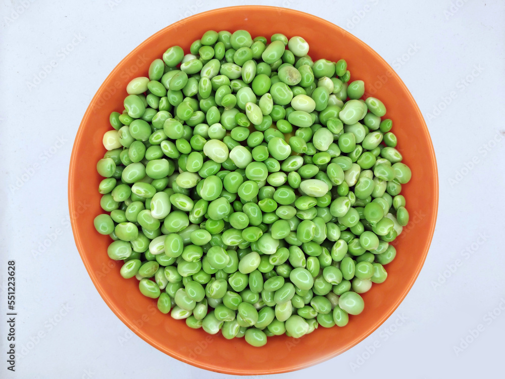 Green pigeon pea beans isolated on background, Green Toor Dal in orange bowl Green pigeon pea beans isolated on background, Green Toor Dal in orange bowl