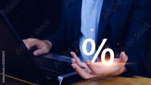 Businessman holding with percentage sign, monetary growth, interest rate increase, inflation concept, Interest rate financial and mortgage rates concept.